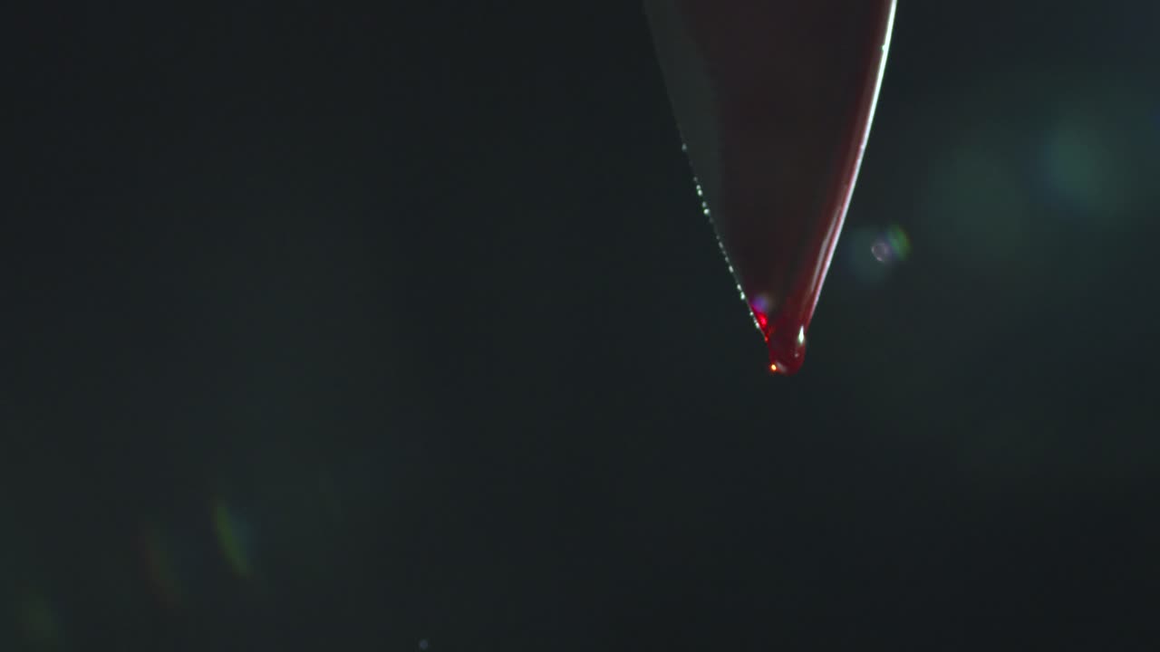 Blood Dripping from Tip of Knife
