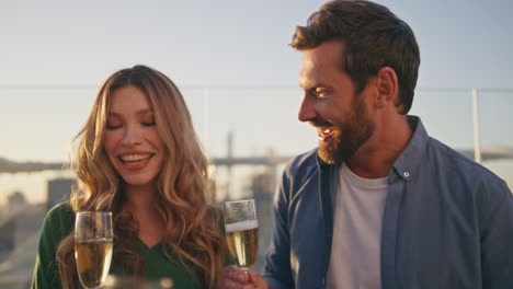 celebrating people pouring champagne enjoying sunny rooftop party close up.