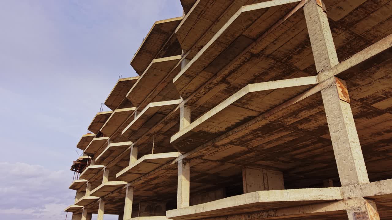 Construction site with unfinished structure viewed from above