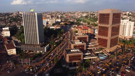 Aerial,-busy-downtown-traffic-and-office-buildings-in-Yaonde,-capital-of-Cameroon