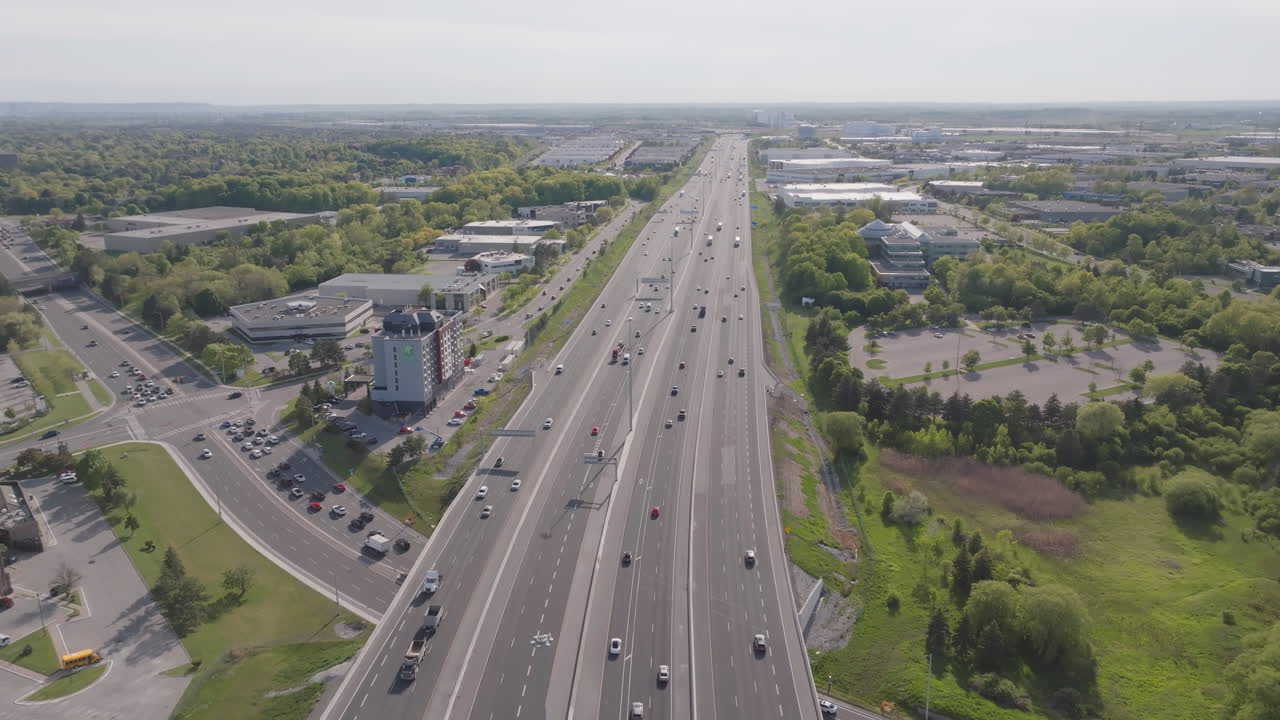 Mississauga highway 401, showcasing traffic and green spaces, aerial view