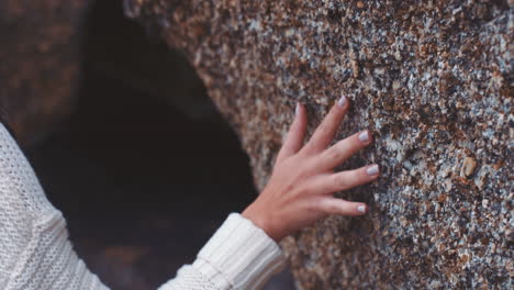 nature, mountain cave and touch of woman hand