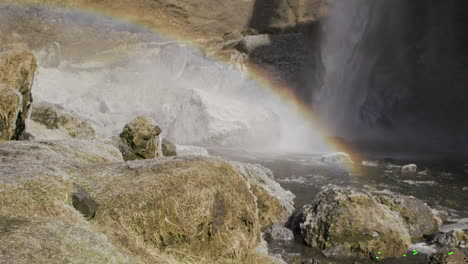 arco iris frente a una cascada en cámara lenta de islandia