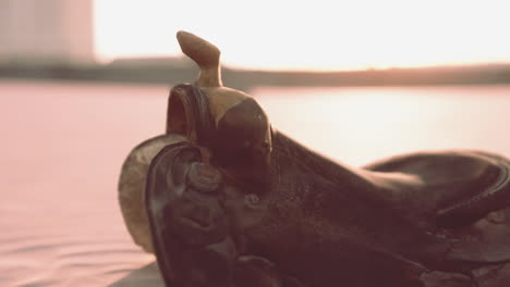 old western saddle by the water