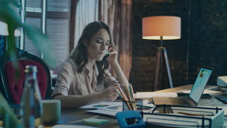 upset business woman using phone in cozy studio. depressed businesswoman