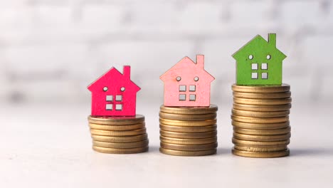 the concept of finance concept with stack of coins and house on table