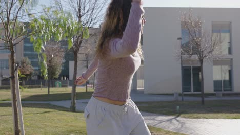 young woman dancing freestyle in a city park
