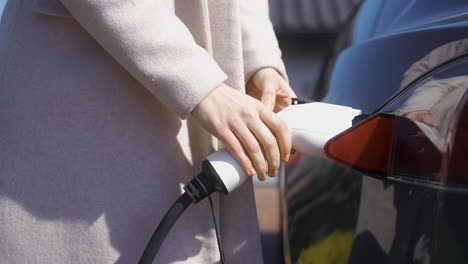 woman charging an electric car