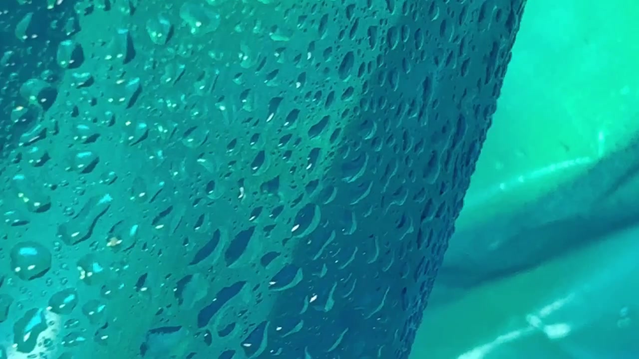 Abstract Background of Water Droplets on Teal Plastic Surface