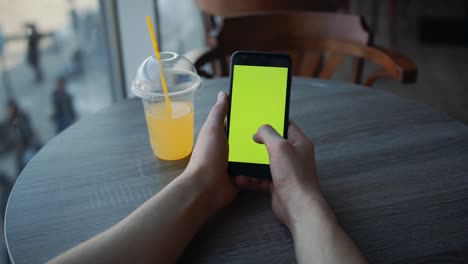 blank digital smartphone in hand of men, mobile phone green screen