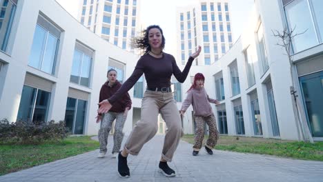 young urban dancers performing energetic routine outdoors