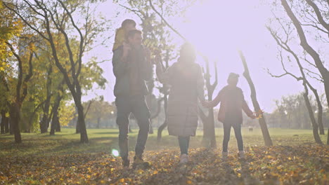 family walking in the park during autumn