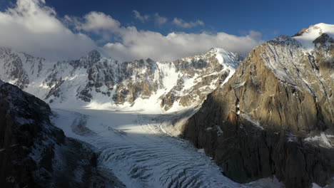 Epic-cinematic-drone-shot-of-a-large-passage-through-the-mountains-of-the-Ak-Sai-glacier-in-Kyrgyzstan