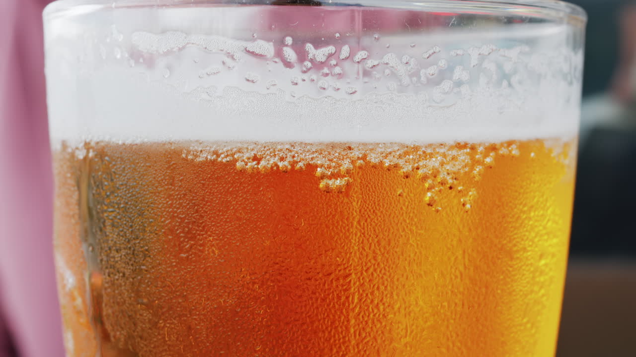 Close up of bubbles forming into foam in a beer glass