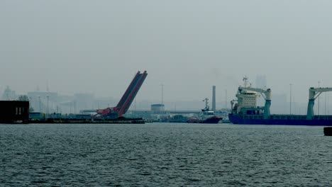 timelapse bridge lowering after tugboat helps ship navigate through dock gate