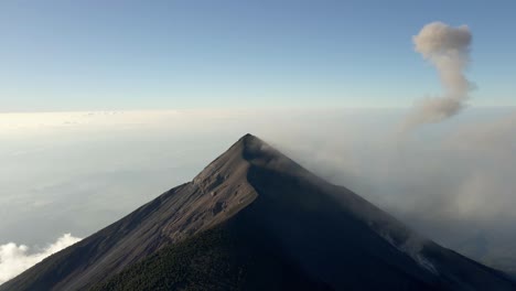 medium aerial establishing of volcano fuego with active plume of smoke, showing rugged volcanic detail and texture
