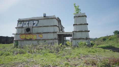 Strange-structure,-steel-panels,-post-apocalyptic-scene,-overgrown-weeds