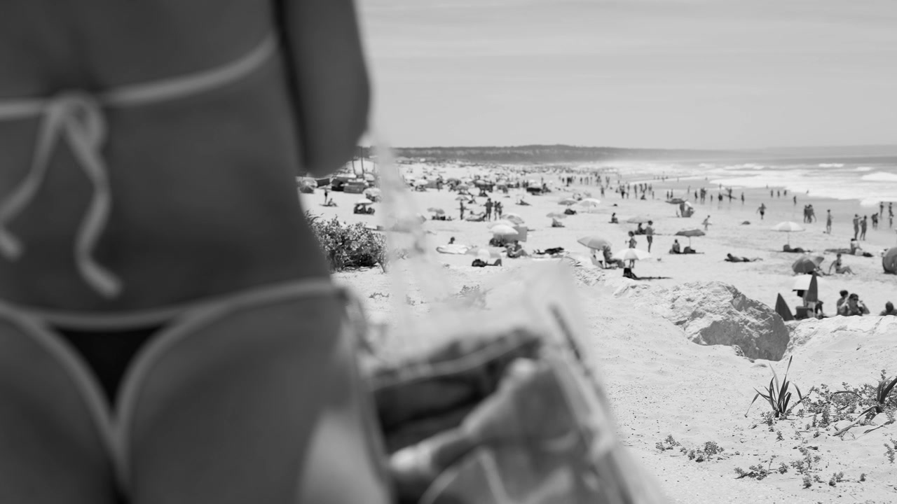 Black and White View of a Crowded Beach with People and Ocean