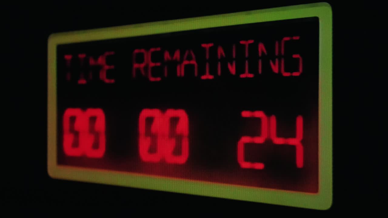 Real TV capture: a shaky countdown timer, red LCD numbers going down to zero on a big display