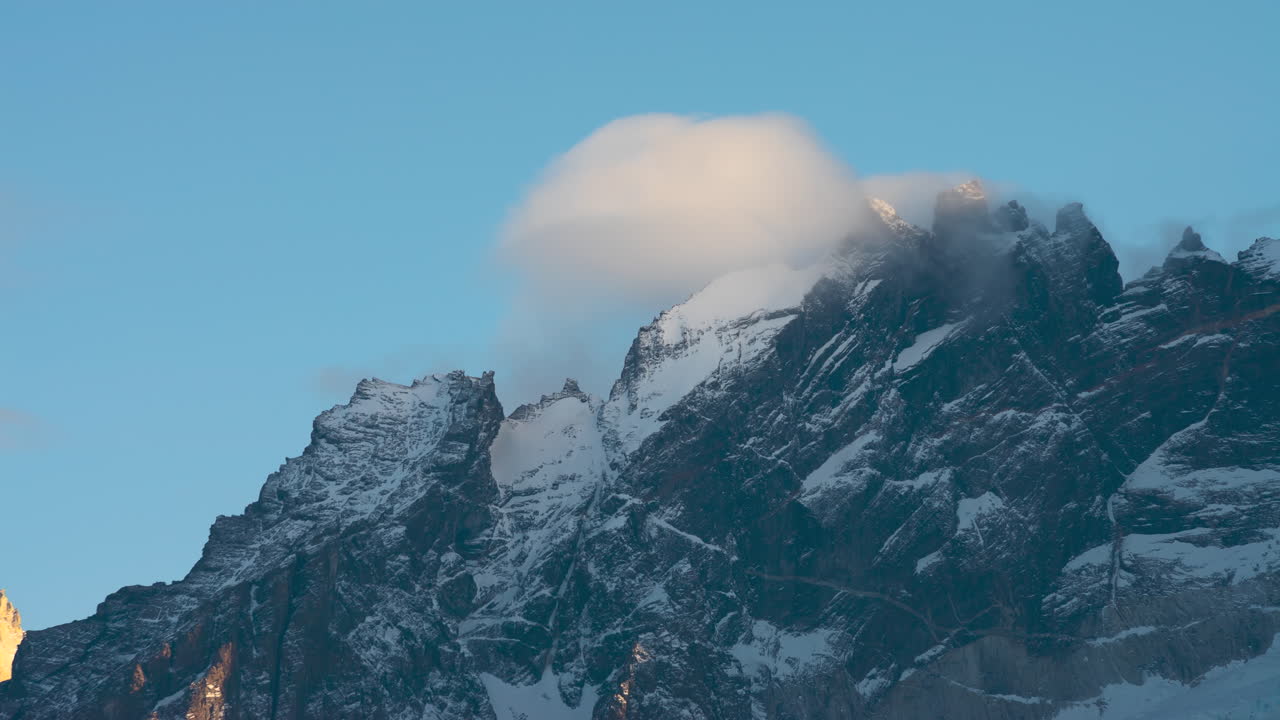 Majestic Snow-Covered Mountain Peak with Clouds