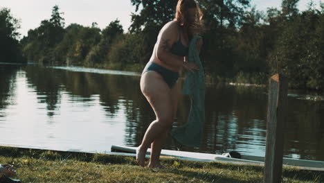 woman drying off by the lake