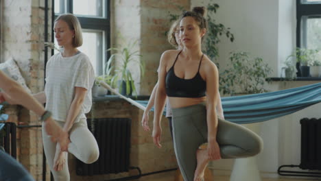 girls doing tree pose on yoga class