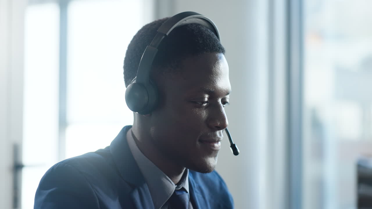 Smiling African American Man Talking on Headset in Office