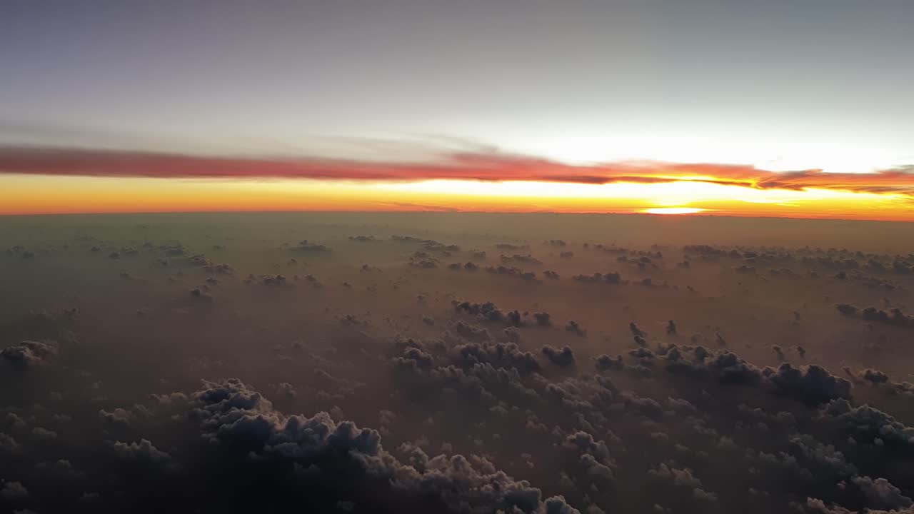 Aerial cinematic cloudscape of incredible dawn with warm orange colors