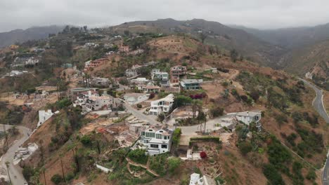 Close-up panning aerial shot of homes affected by the Palisades Fire at Las Flores Canyon in Malibu, California. 4K