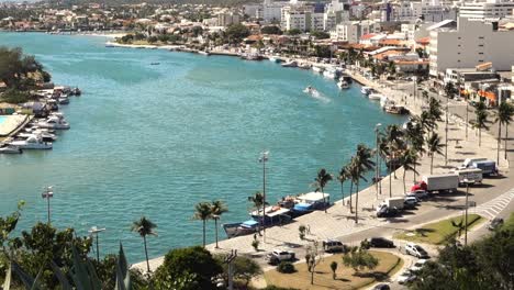 Tilt-up-reveals-the-Araruama-lagoon-channel-flowing-towards-sea-in-Cabo-Frio,-Brazilian-coast