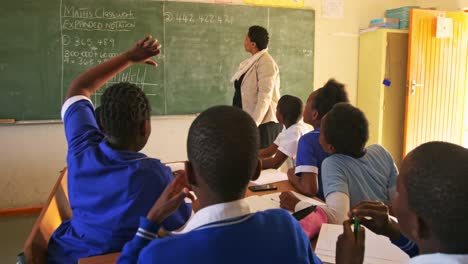 female teacher and young pupils working in class 4k