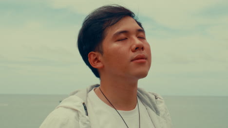 man looking at the ocean