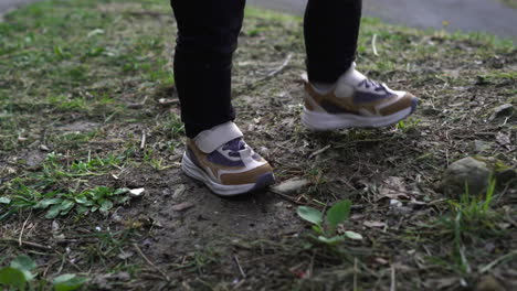 Gimbal-shot-of-toddler-feet-walking-on-grass