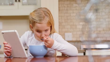 little girl using tablet while having breakfast 4k 4k