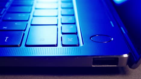 closeup of young man hands turning on laptop macbook at night working