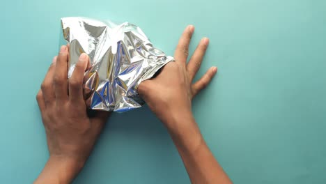 hands opening a foil packet