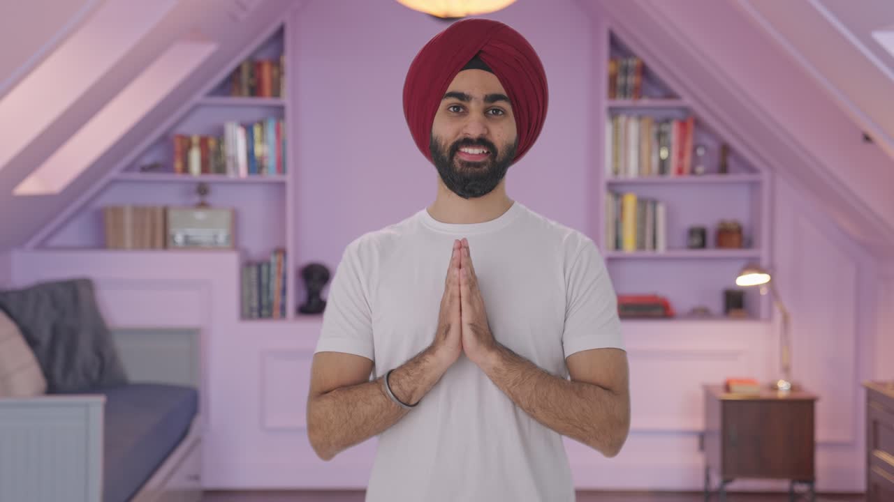 Happy Sikh Indian man greeting and doing Namaste