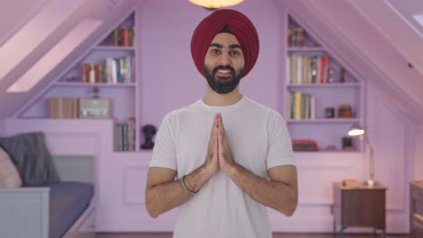 happy sikh indian man greeting and doing namaste