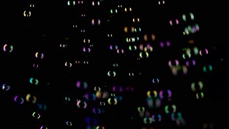 medium soap bubbles spinning slow motion black background medium sized bright soap bubbles spinning slow motion black background