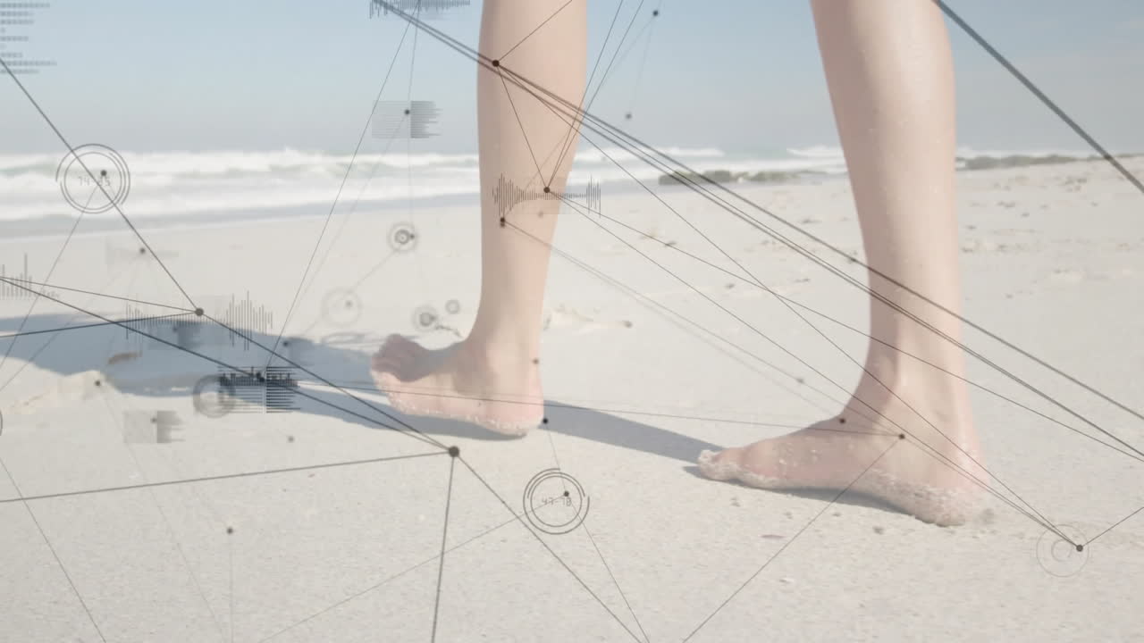 Bare feet walking on sandy beach with digital network overlay animation