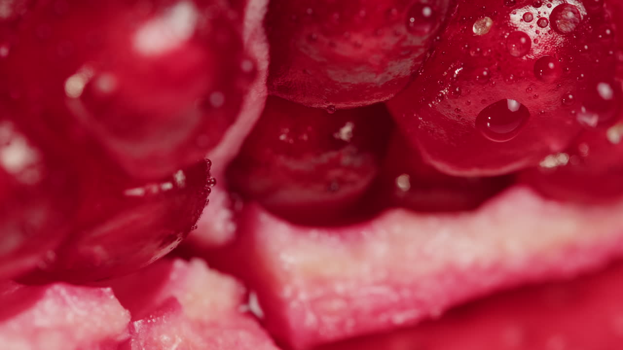 Water Dripping on Fresh Pomegranate Seeds Macro Shot
