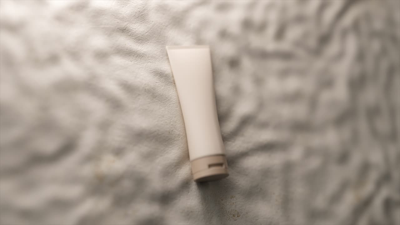 tubo blanco de crema en una superficie texturizada