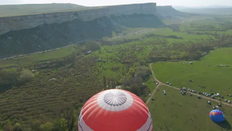 hot air balloon festival in a valley landscape