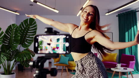 young woman dancing and recording a video for social media