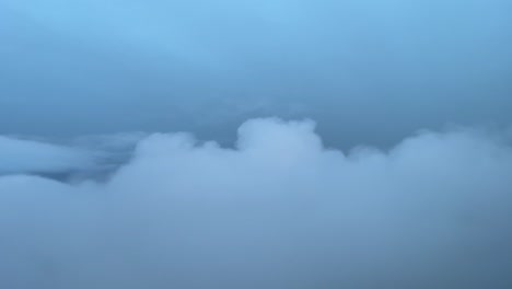 Aerial-jet-view-from-a-jet-cockpit-while-flying-trough-layers-of-winter-clouds