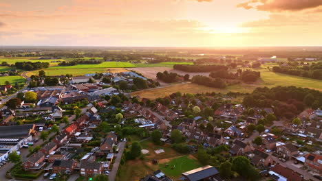 sunset over a peaceful rural landscape. golden sunset casts warm light over a quiet village surrounded by expansive fields and lush greenery