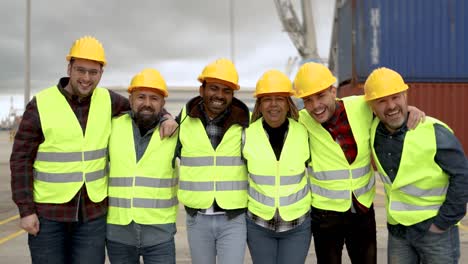 multiracial worker people having fun inside container cargo terminal at maritime port