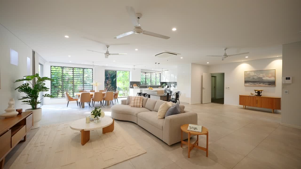 Spacious loungeroom in a modern luxury home, featuring stylish furniture and large windows