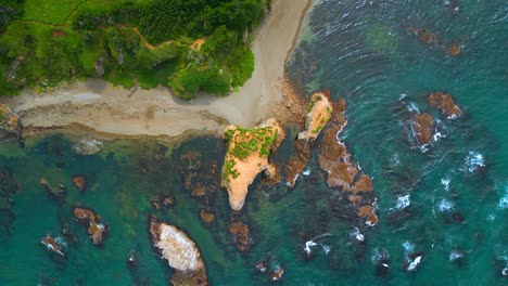 aerial view of coastal landscape with rocks and beach