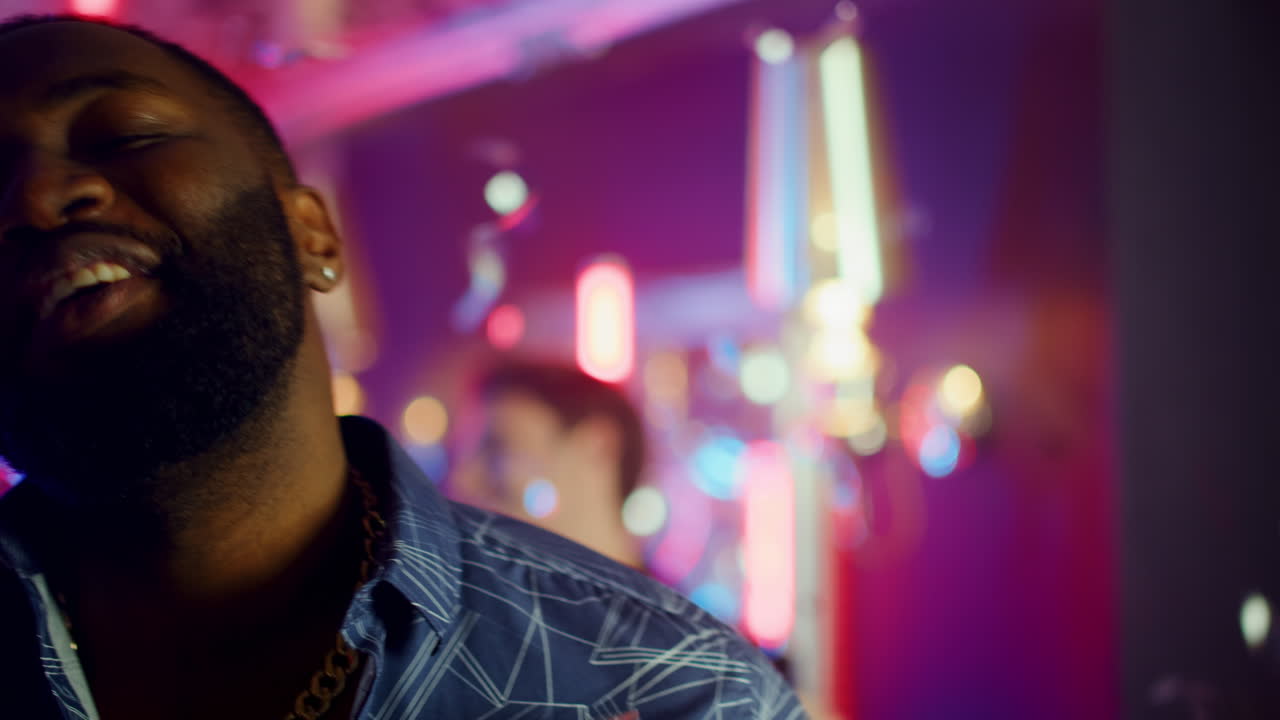 African american guy singing in club. African man making face expression in club